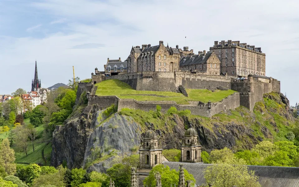 Edinburgh Castle rising above the grassy slopes of Castle Rock