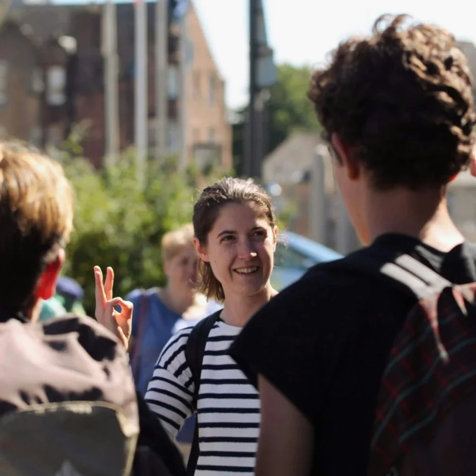 Guide speaking with visitors during an Edinburgh food walk