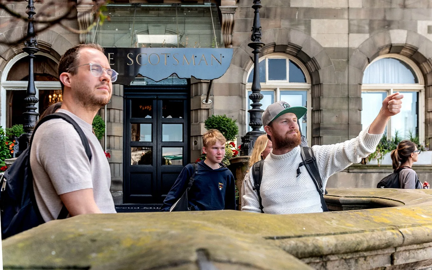 Guide pointing out Old Town sights during a themed walking tour