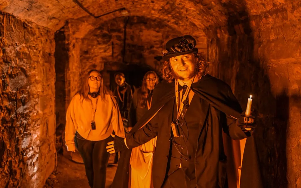 Costumed guide telling stories in the Blair Street Underground Vaults