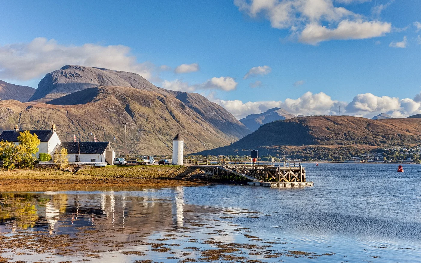 Stone church beside a Highland loch and mountains
