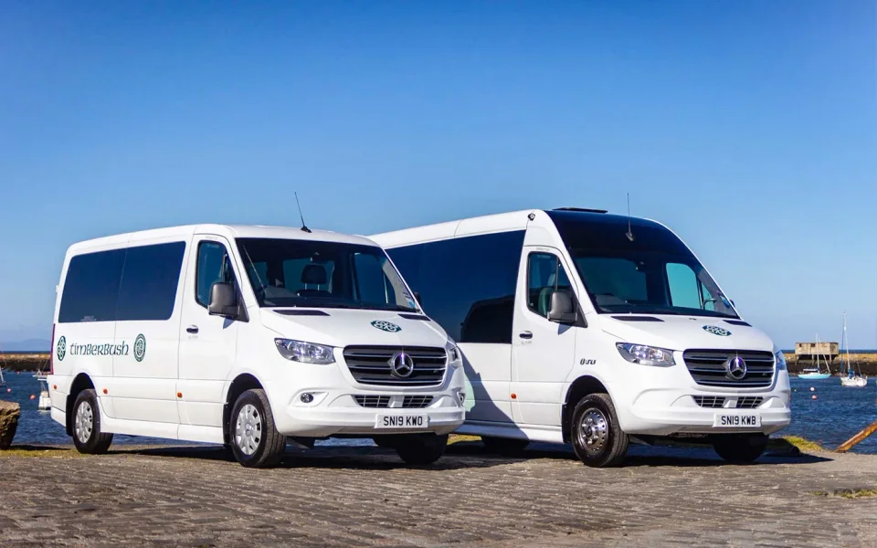 Minibus da tour parcheggiati accanto al paesaggio delle Highlands