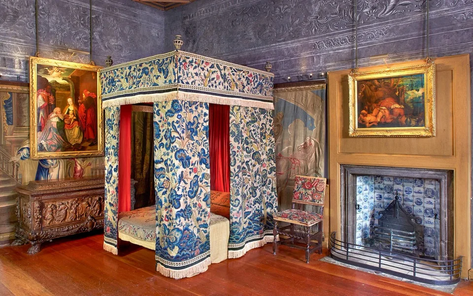 Historic canopied bed and ornate furnishings at the Palace of Holyroodhouse