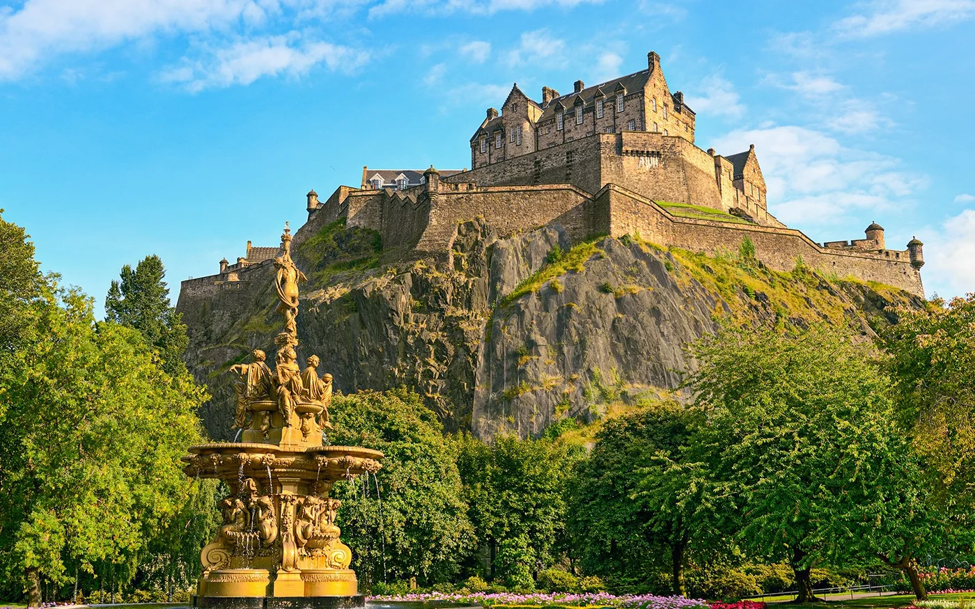 Edinburgh Castle seen above trees and gardens