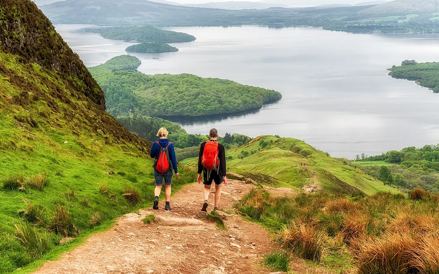 Walkers overlooking the islands and water of Loch Lomond